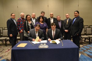 USET Tribal leadership looks on as USET President Brian Patterson and SBA Office of Native American Affairs Assistant Administrator Chris James signs the Strategic Alliance Memorandum.