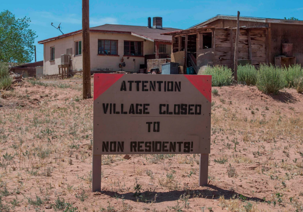 A sign warns nonresidents to stay out of the Navajo Nation town of Tuba City in Arizona in an attempt to stop the spread of covid-19. (Mark Ralston/AFP via Getty Images)